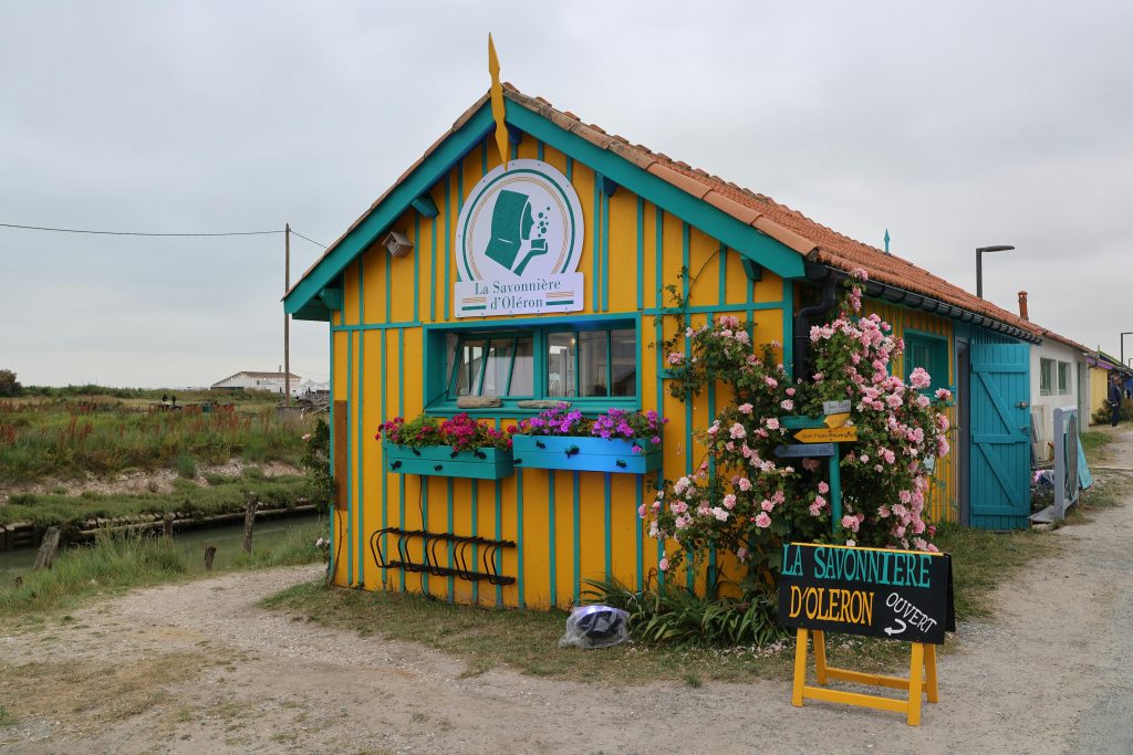 Colorful soap shop with flowers on Île d'Oléron, France, inviting and picturesque.
